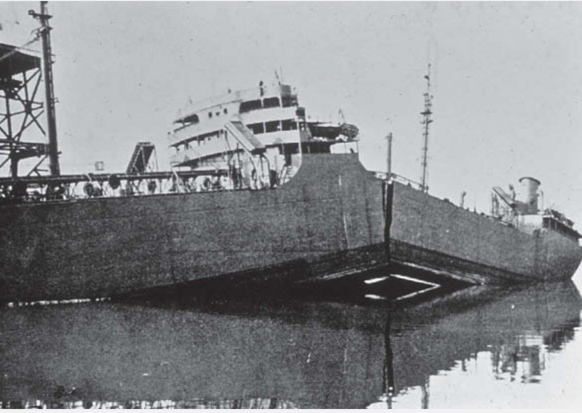 Black and white photograph of a Liberty-class ship with a fractured hull following brittle failure